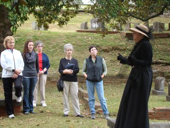 A tour group listening to one of the grave hosts.