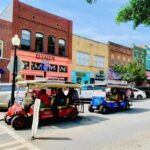 During the Downtown Tour the golf carts pass colorful storefronts line the streets and pass by in a lively downtown area.
