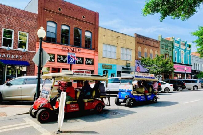 During the Downtown Tour the golf carts pass colorful storefronts line the streets and pass by in a lively downtown area.